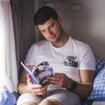 Man lounging in Bunk Campers Horizon motorhome